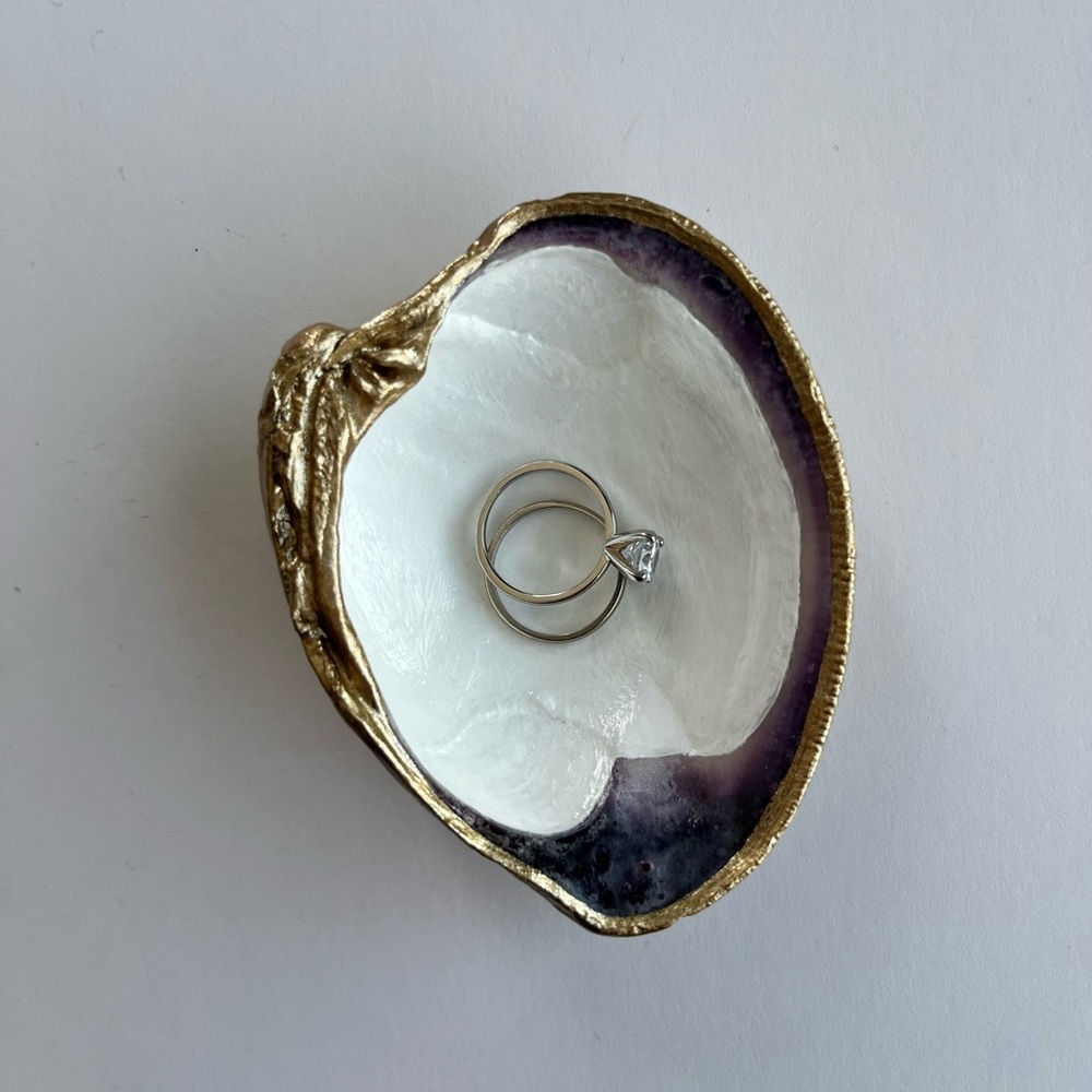 Handmade clam shell ring dish. White and purple inside, with gold trim.